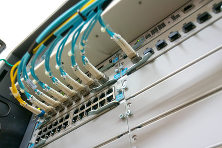 Image showcasing a close-up view of network switch equipment in a data center. The setup features...