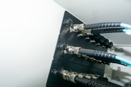 Close-up view of electronic device connections showcasing cables and connectors. This detailed image...