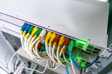 Close-up of network connectivity equipment featuring colorful cables for efficient data transfer,...