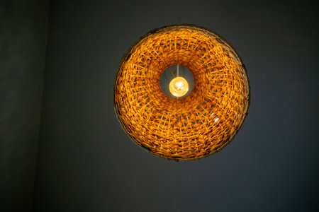 Stunning woven light fixture captures attention with its artistic design, perfect for adding warmth and charm to any interior space.の写真素材