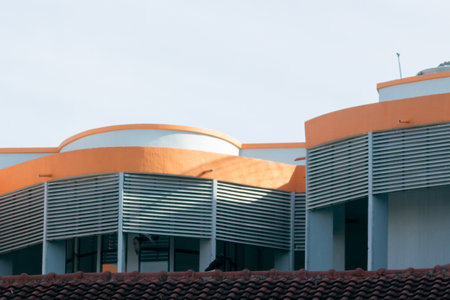 This image showcases an abstract view of a modern architectural detail featuring orange and white curves, creating an interesting geometric composition.の写真素材