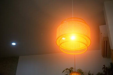 A beautifully designed rattan pendant light creating warm illumination in a stylish interior, perfect for enhancing modern home decor and atmosphere.の写真素材