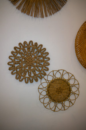 A stunning display of handwoven decorative wall art featuring unique circular designs. Perfect to enhance any home with natural elegance and texture.の写真素材