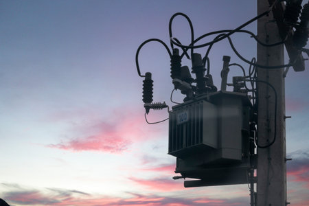 An electric transformer mounted on a power pole, showcasing essential infrastructure for electricity distribution and connectivity in urban and rural settings.の写真素材