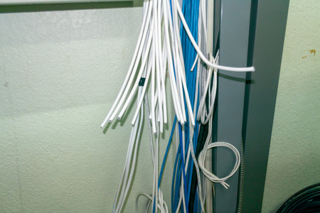 A chaotic arrangement of cables in storage, showcasing various colors and types of wires. Ideal for themes related to technology, organization, and connectivity.の写真素材