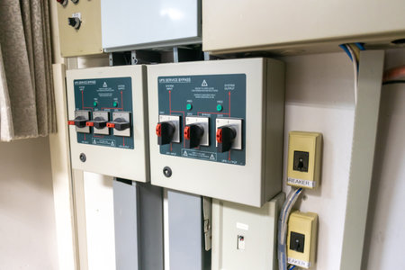 This image features a close-up view of electrical panels with circuit breakers and controls, showcasing the essential elements of modern power distribution and safety systems.の写真素材