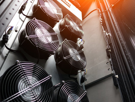 Close-up view of cooling fans mounted in a data center rack system, showcasing technology designed for efficient airflow and temperature control in electronic environments.の写真素材