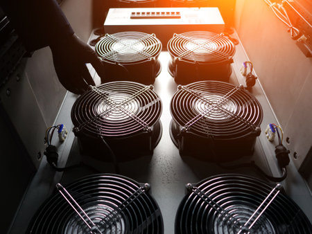 A close-up view of industrial cooling fans housed in an equipment rack, showcasing ventilation systems essential for optimal performance and temperature control.の写真素材