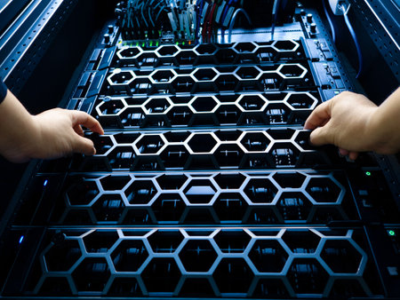 A close-up view of a server rack being managed by hands. The image reveals intricate technology components, showcasing efficient data storage and hardware maintenance.の写真素材
