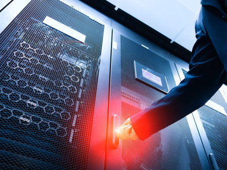 A professional individual interacts with a server in a modern data center, highlighting technology and management in a secure digital environment.の写真素材