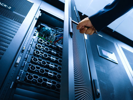 A professional hand is opening a server rack door in a modern data center. The scene showcases cutting-edge technology and intricate hardware setup.の写真素材