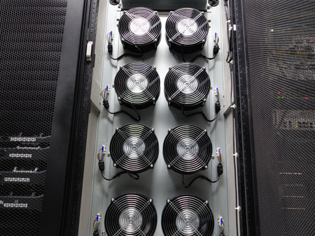 A close-up view of multiple cooling fans inside a data center rack, illustrating the importance of temperature management in technology infrastructure.の写真素材