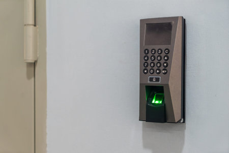 A modern biometric access control system featuring a fingerprint scanner and keypad. Ideal for...