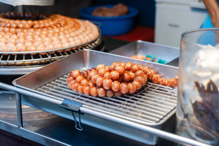 A delicious array of sweet fried dough balls served on a metal tray, showcasing vibrant colors and...