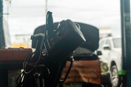 A camera positioned in a workshop captures the essence of auto service and repair, showcasing the tools and vehicles in a blurred yet engaging manner.の写真素材