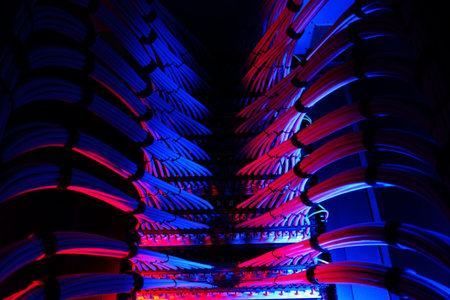 A vibrant display of network cables illuminated in blue and red tones, showcasing technology in a...