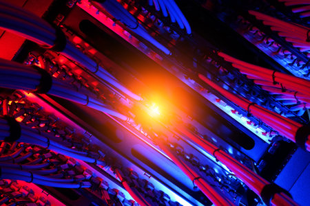 A captivating view of electric cables illuminated in blue and red light. The intricate patterns and...