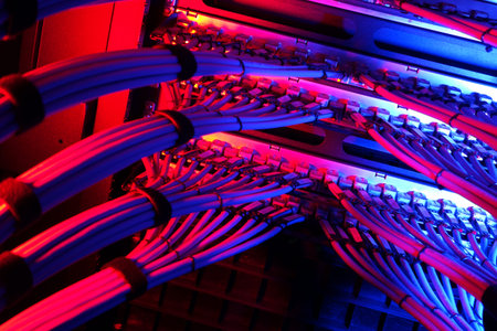 A visually striking image of vibrant network cables within a data center. The cables are beautifully...
