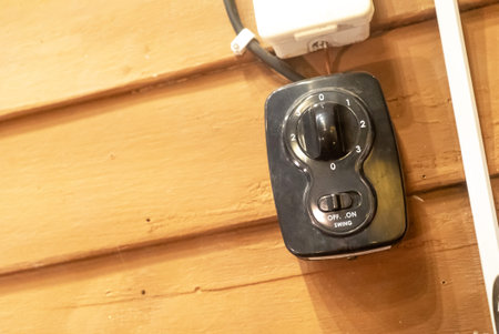 This image showcases a wall switch used for controlling lights and fans, featuring a sleek design...
