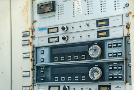 Close-up view of a vintage control panel showcasing various meters, buttons, and dials, emphasizing...