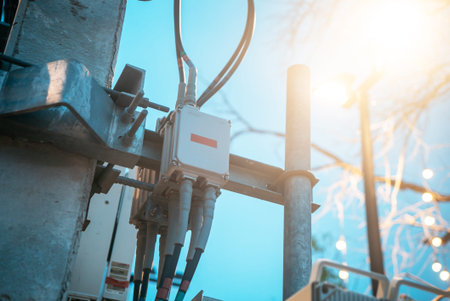 A close-up view of electrical equipment installed on a utility pole, showcasing wiring and...