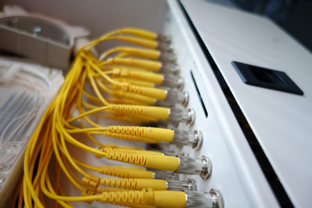 Close-up view of bright yellow cables connected to a network panel. Perfect for showcasing...