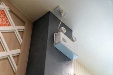 A wall-mounted air conditioning unit positioned in a corner, showcasing modern design and...