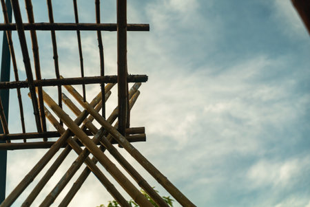 A captivating view of a wooden structure set against a vibrant blue sky. The interplay of natural materials and clouds creates an inspiring composition.の写真素材