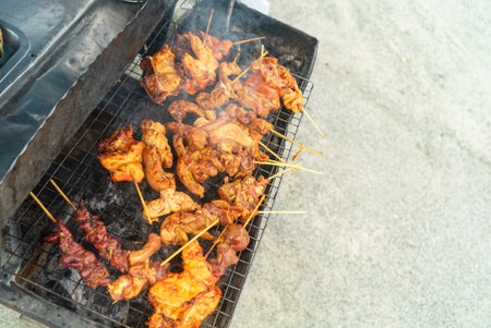 A vibrant display of assorted meat skewers on a barbecue grill, sizzling in smoke. Perfect for...