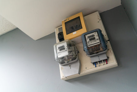 This image features modern electric meters mounted on a wall, showcasing advanced technology for...