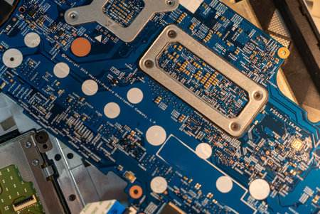 Close-up view of a blue circuit board showcasing various components and intricate designs,...