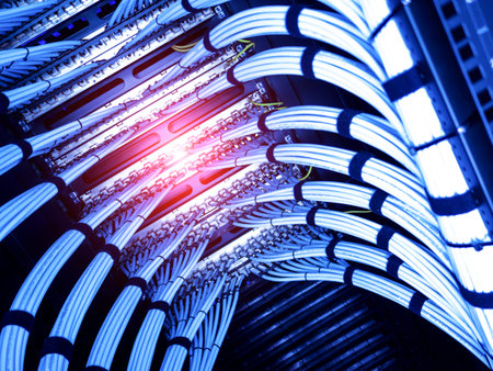 A captivating view of modern data center cables illuminated in blue light. This image showcases the...