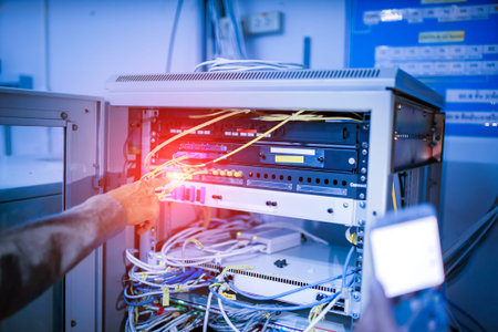 A detailed view of network equipment showcasing colorful cables and connections in an office...
