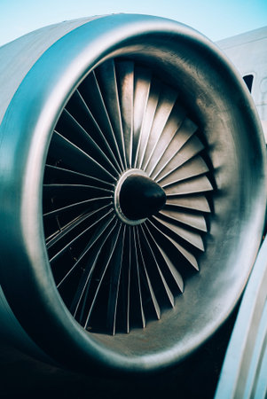 Detailed close-up of a jet engine turbine fan, showcasing its intricate design and engineering. Ideal for aviation and technology-related themes.