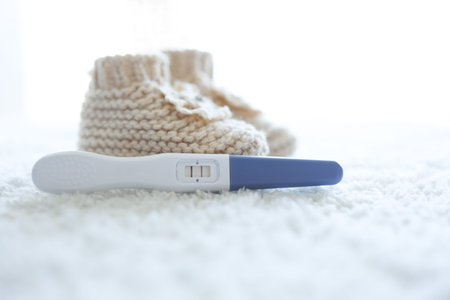 Positive pregnancy test and knitted socks for a newborn