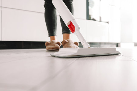 Cleaning Service Woman Mopping The Floor In Kitchen At Home