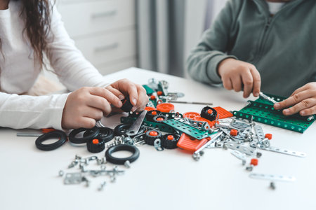 Children play with a metal constructor.
