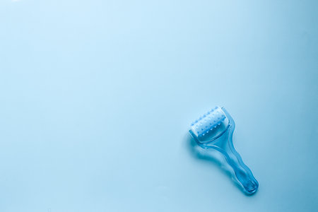 Top view plastic hand massager on blue background.の写真素材