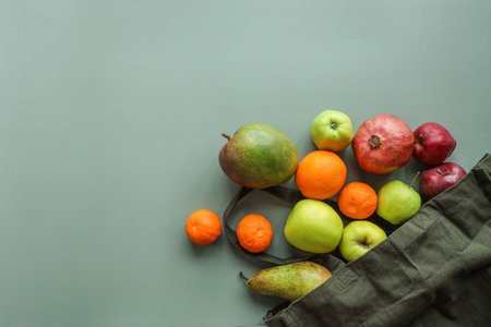 Eco bag with products on color background.