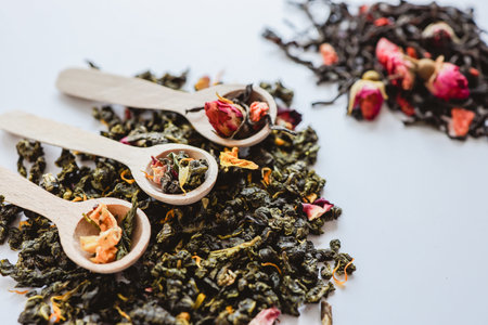 Herbal tea close-up in wooden spoons.