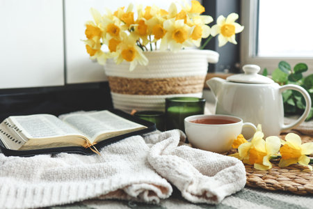 Open Bible in a cozy home interior. Good morning.の写真素材