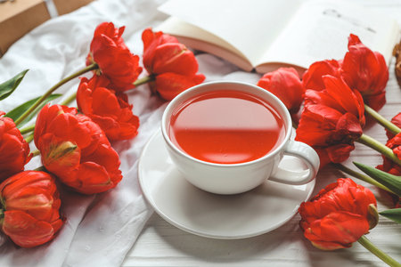 Beautiful spring composition, good morning concept. Cup of tea, peonies, open book.の写真素材