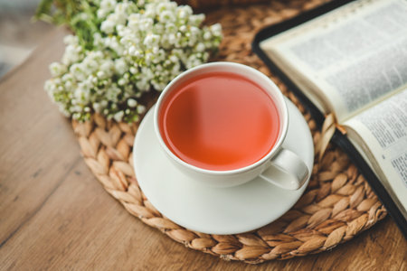 Cup of tea, open bible and flowers, good morning.の写真素材