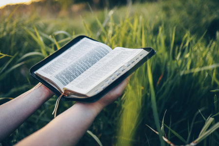 Open bible in hands close-up, concept of calmness and morning solitude.の写真素材
