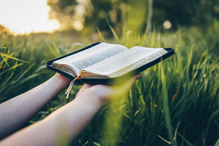 Open bible in hands close-up, concept of calmness and morning solitude.