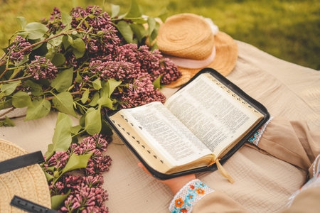 Girl reading the bible in the garden, Christian concept.
