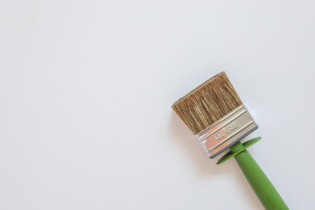 Brush for painting walls on a white background top view flat lay.