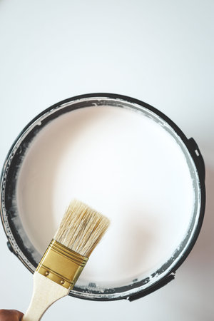 Paint brush resting on paint tin viewed from above.の写真素材