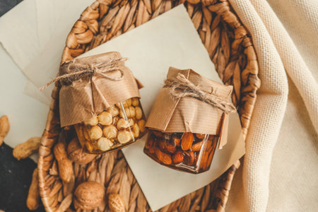 Craft jars with honey and nuts top view.