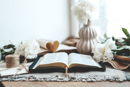 Open bible in home morning interior.